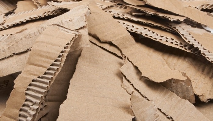 A large pile of cardboard that has been torn into narrow strips.