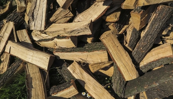 A pile of oak wood, split and ready to burn.