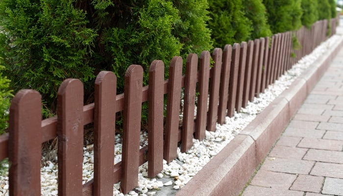 A small brown garden fence used as decorative edging.