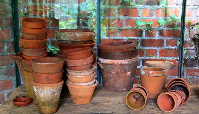 Stacks of old flower pots in a quaint garden shed.